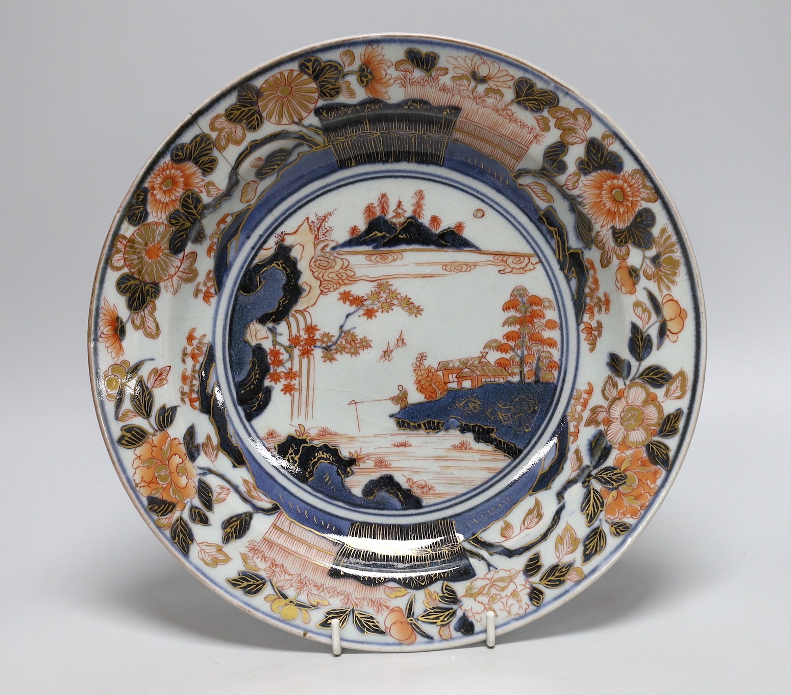 A Japanese Arita dish, late 17th century, painted in Imari palette, stilt marks, cracked, 28cms diameter